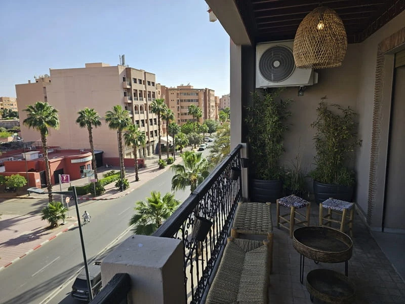 Balcony view over a residential street in Marrakech.